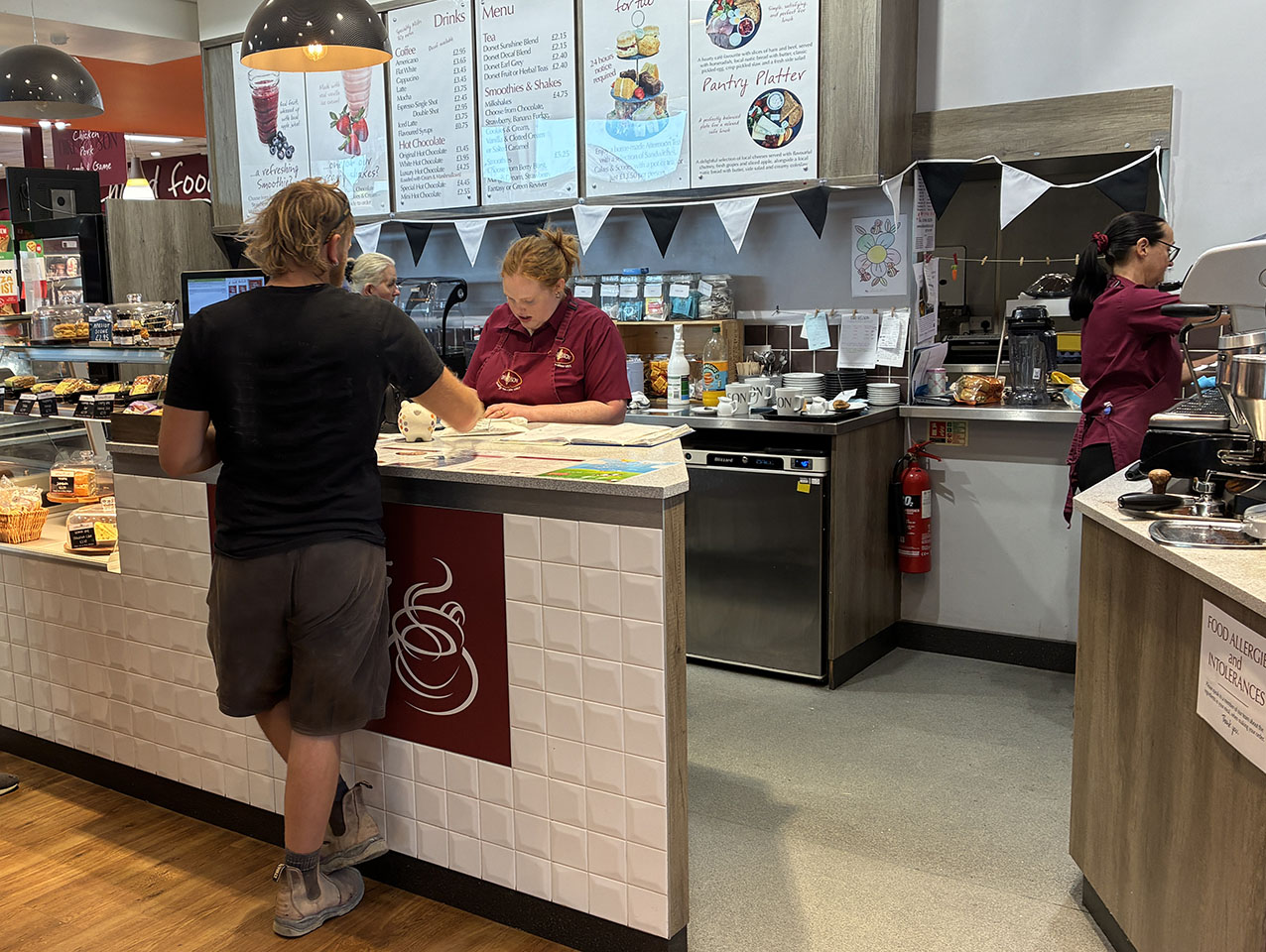 Man being served at the Cafe counter in the shop