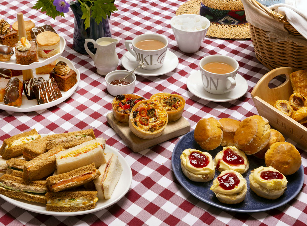 Afternoon tea including sandwiches, scones, cakes, mini quiches and sausage rolls